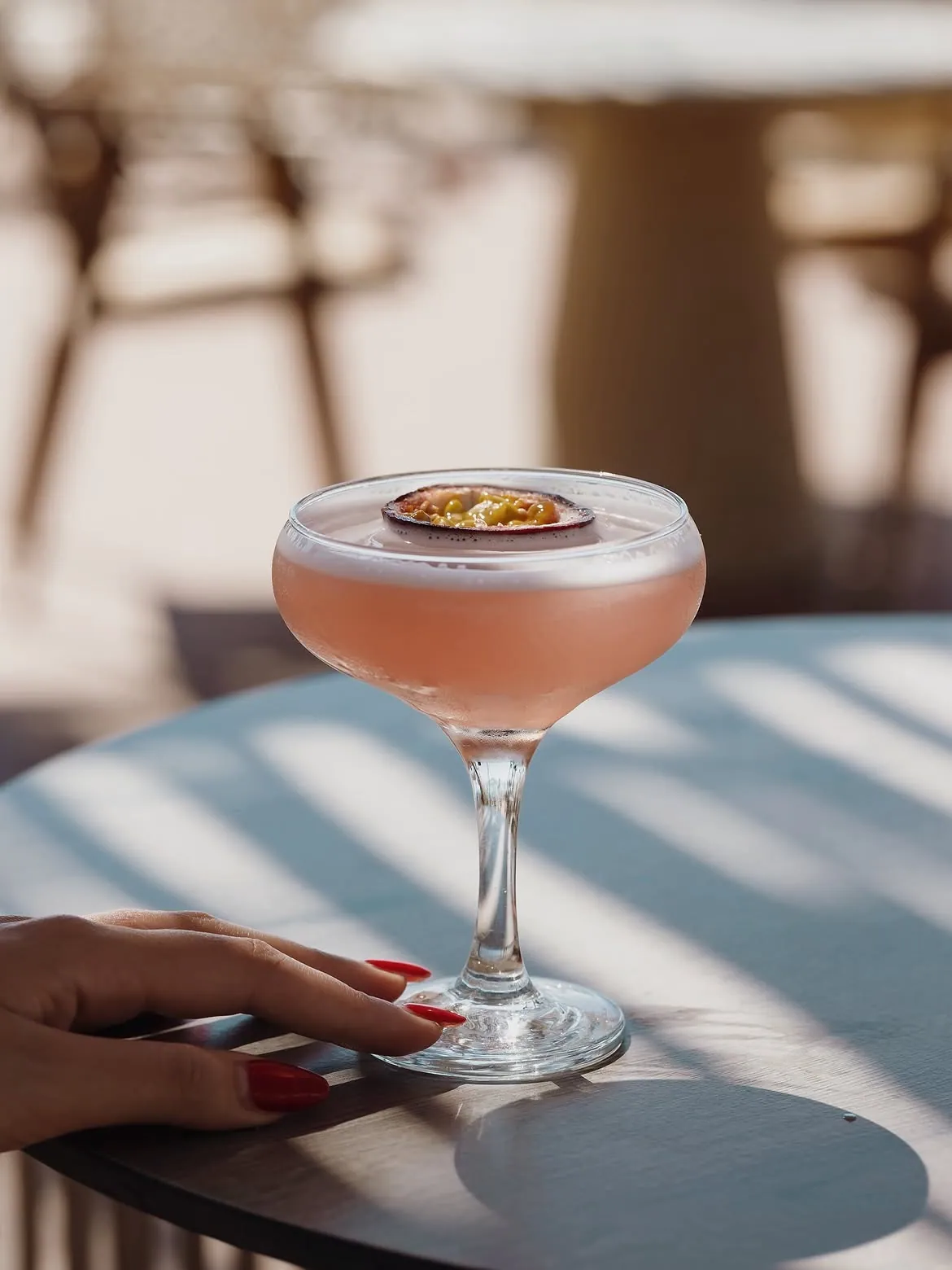 Pink signature cocktail at sunset at BOJO Resort beach bar