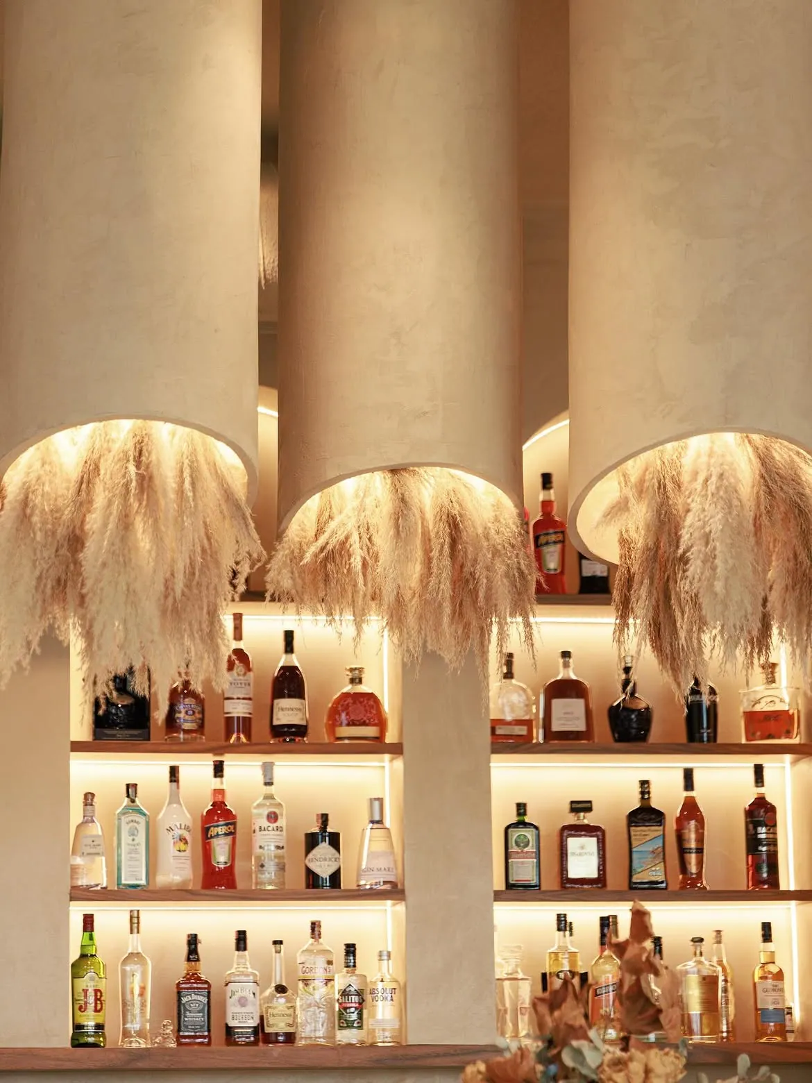 The lounge bar at BOJO Resort with a curated cocktail shelf on the Albanian Riviera